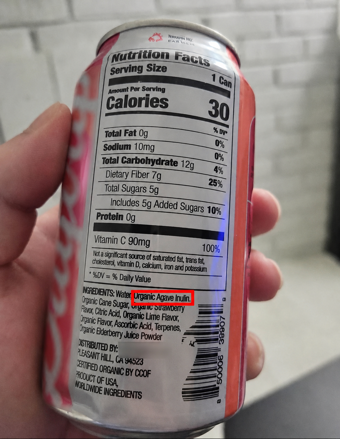 Close-up of a beverage can showing Nutrition Facts and an ingredients list, with “Organic Agave Inulin” highlighted as a source of prebiotic fiber.